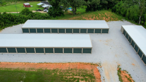 Aerial view of rows of drive-up self-storage units with green roll-up doors in Elberton, Georgia